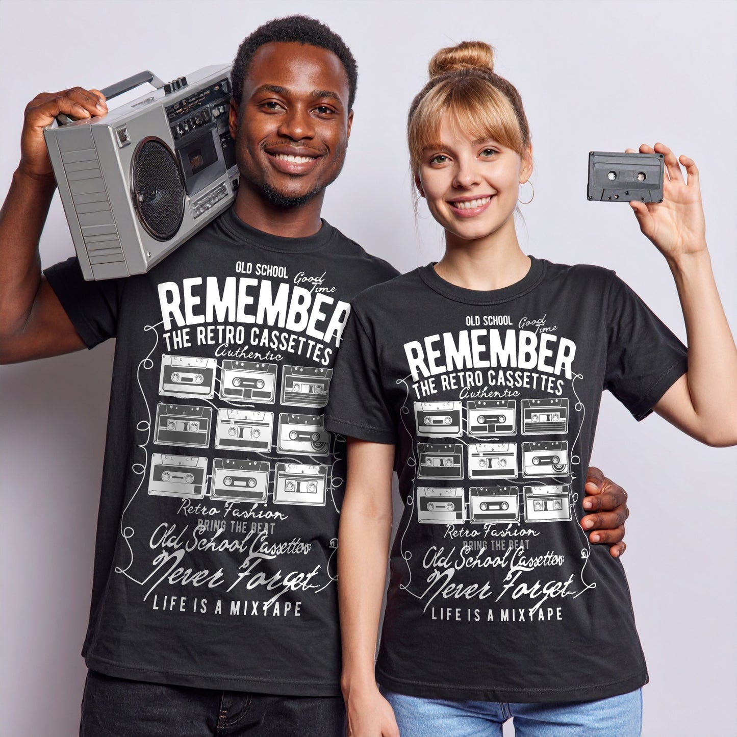 Two people wearing Black Old-school music lover’s tee featuring colourful cassette tapes and fun retro typography., holding a boombox and cassette tape.