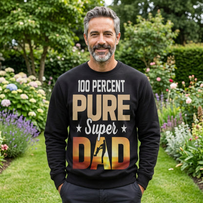 Person wearing a black “100 Percent Pure Super Dad” sweatshirt outdoors, featuring sunset‑gradient dad and child silhouette — Father’s Day gift apparel.