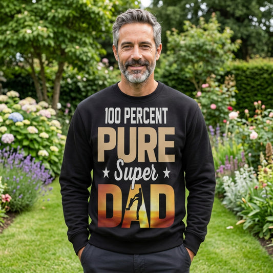 Person wearing a black “100 Percent Pure Super Dad” sweatshirt outdoors, featuring sunset‑gradient dad and child silhouette — Father’s Day gift apparel.