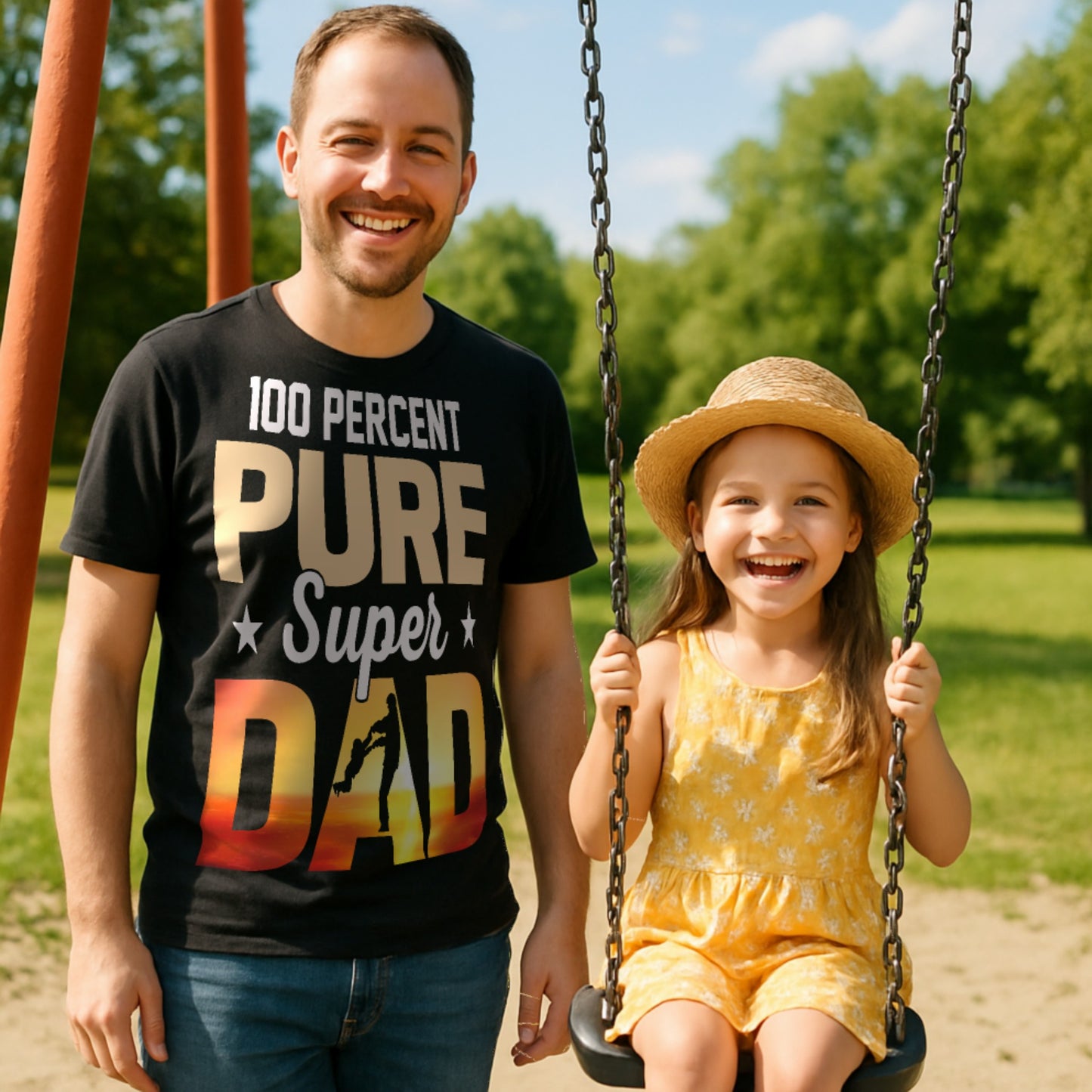 Man wearing a '100 Percent Pure Super Dad' shirt with a child on a swing in a park.