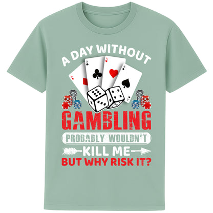 A unisex aloe colour T-Shirt, featuring a gambling-themed design with playing cards, dice, and poker chips. The text reads: 'A day without gambling probably wouldn’t kill me, but why risk it?' in bold white, red, and blue fonts."
