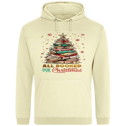 Vanilla milkshake colour All Booked For Christmas hoodie featuring a Christmas tree made from stacked books with festive lights and a golden star, a cosy Christmas book lover hoodie for readers, bookworms, librarians, and holiday reading.