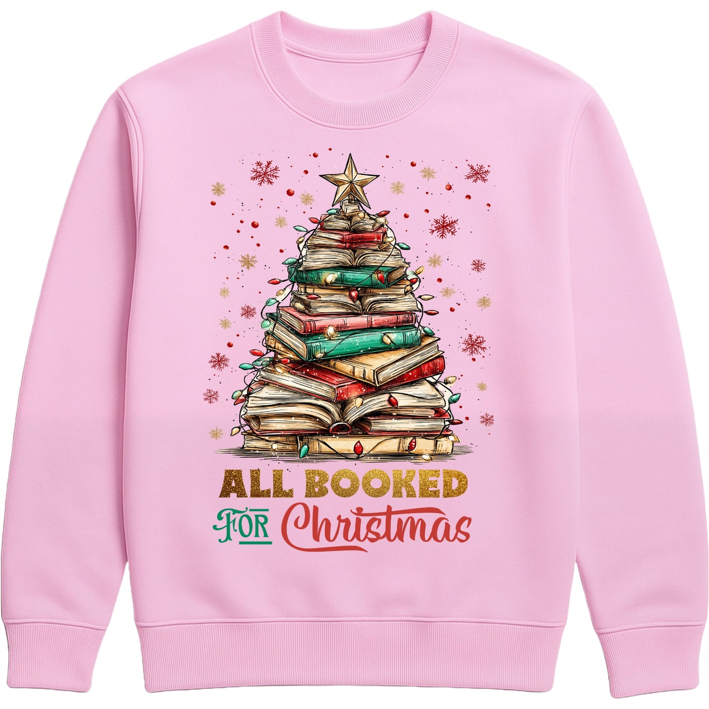 Pink “All Booked for Christmas” sweatshirt featuring a whimsical book-stack Christmas tree with lights and a star, styled in a cozy holiday aesthetic.