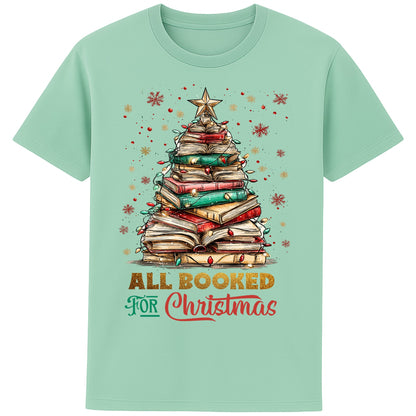 Misty Jade colour festive bookish Christmas t-shirt featuring a Christmas tree made of stacked books, surrounded by twinkle lights and warm winter vibes.