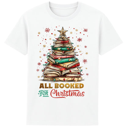White festive bookish Christmas t-shirt featuring a Christmas tree made of stacked books, surrounded by twinkle lights and warm winter vibes.