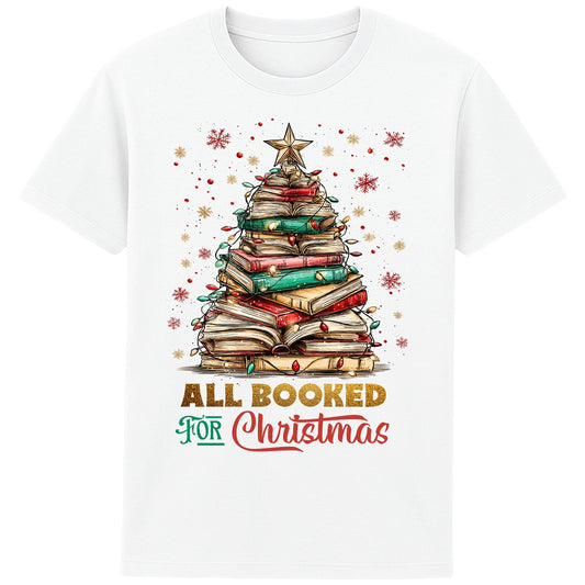 White festive bookish Christmas t-shirt featuring a Christmas tree made of stacked books, surrounded by twinkle lights and warm winter vibes.
