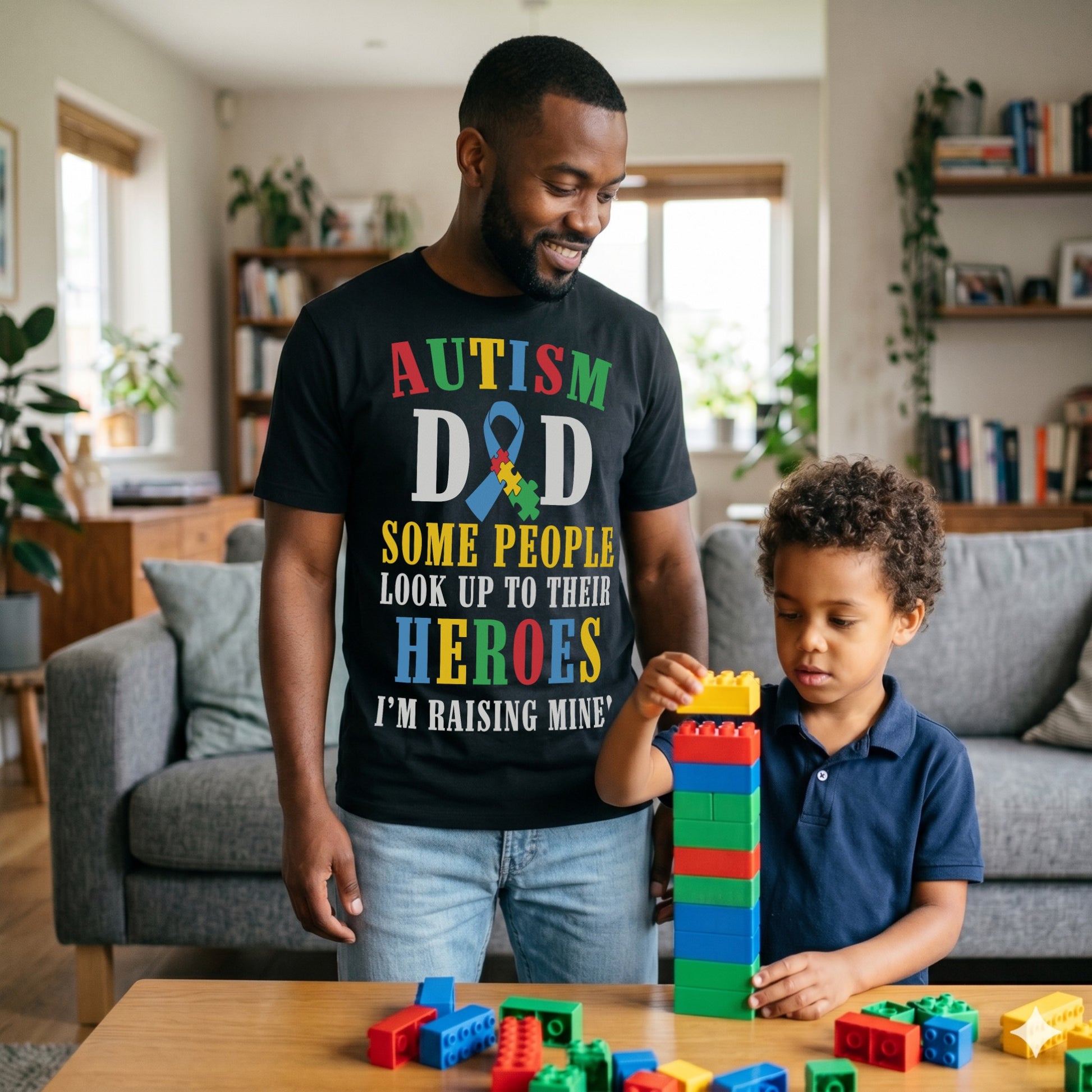 Father wearing an Autism Dad T-Shirt with colourful awareness ribbon and “Some People Look Up To Their Heroes I'm Raising Mine” message while spending time with his child.
