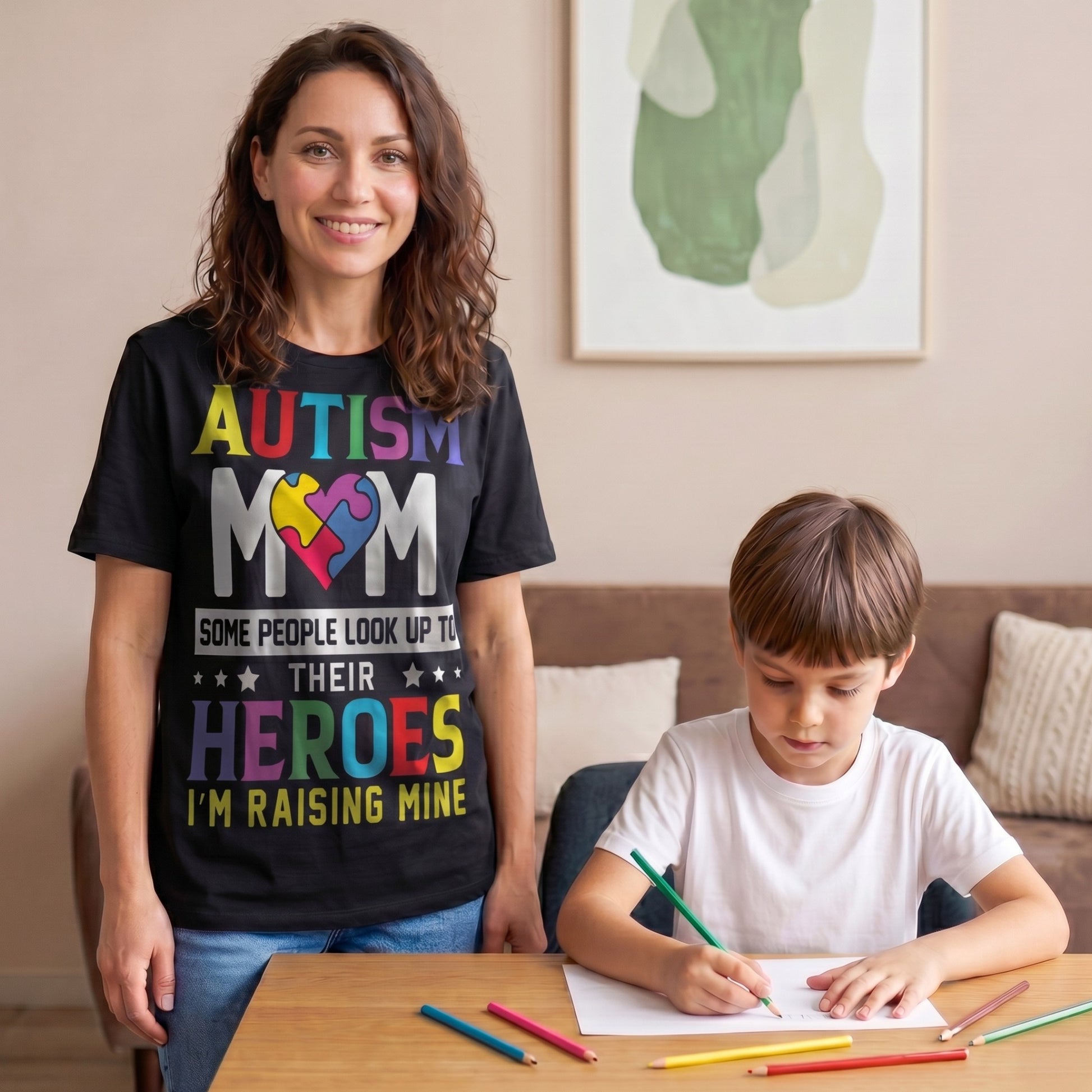 Autism mum wearing a black Autism Mom T-Shirt with colourful puzzle heart design and “Some People Look Up To Their Heroes I'm Raising Mine” message while spending time with her child at home.