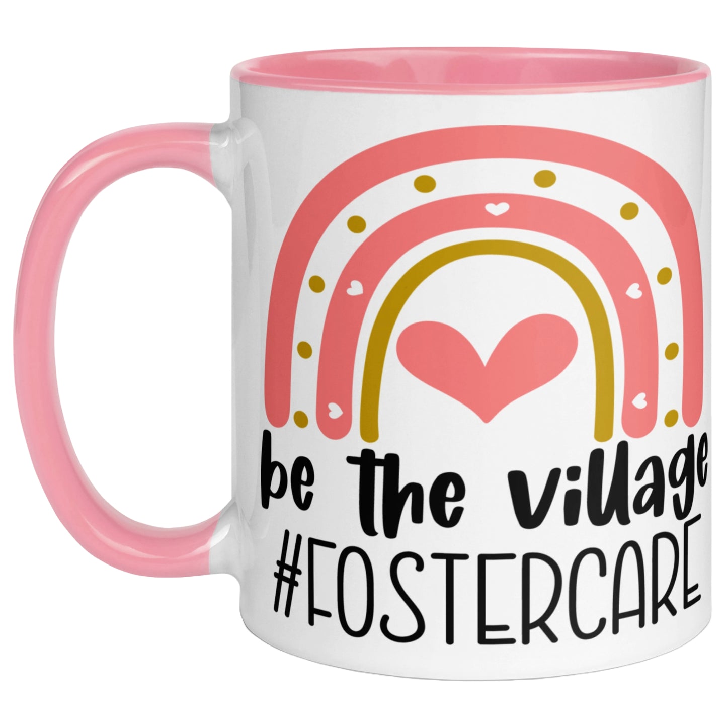 Pink ceramic mug featuring a colourful rainbow, hearts, and the message "Be The Village #FosterCare", celebrating foster care awareness and support for foster families.
