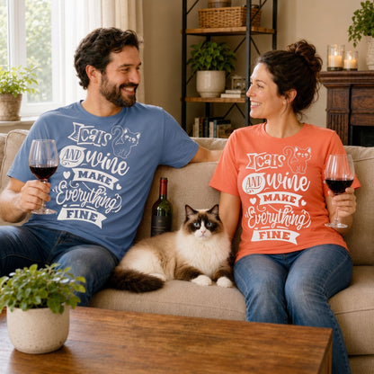 Couple wearing Cats And Wine Make Everything Fine T-shirts while relaxing with a cat and glasses of wine on a sofa.