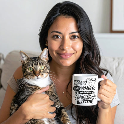 Woman relaxing at home with a tabby cat and a Cats And Wine Make Everything Fine coffee mug featuring a playful cat and wine design.