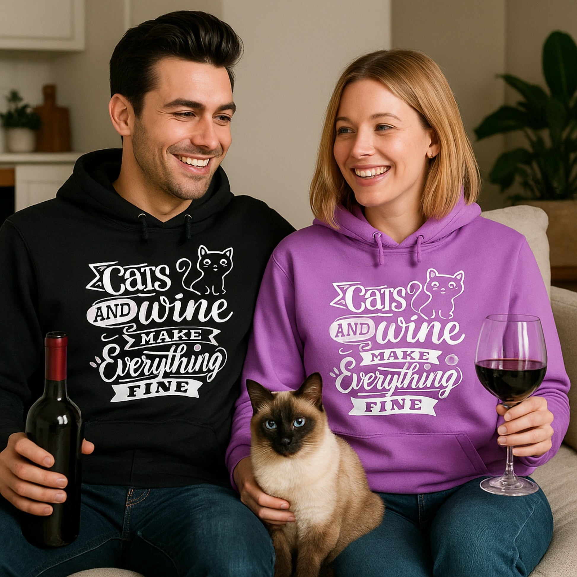 Man and woman wearing matching hoodies with a cat graphic and text saying cats and wine make everything fine,  holding wine and a glass, sitting on a couch.