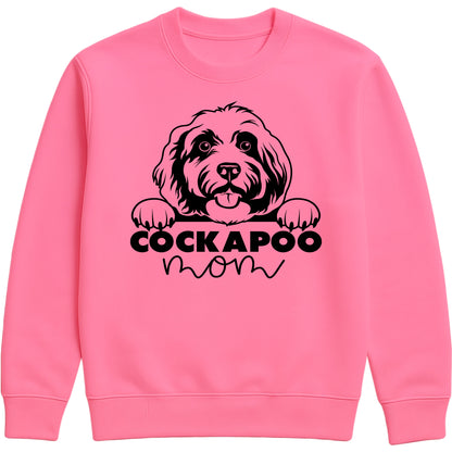 Candyfloss pink sweatshirt with "Cockapoo Mom" text and a cute Cockapoo face graphic, perfect for dog moms and pet lovers.