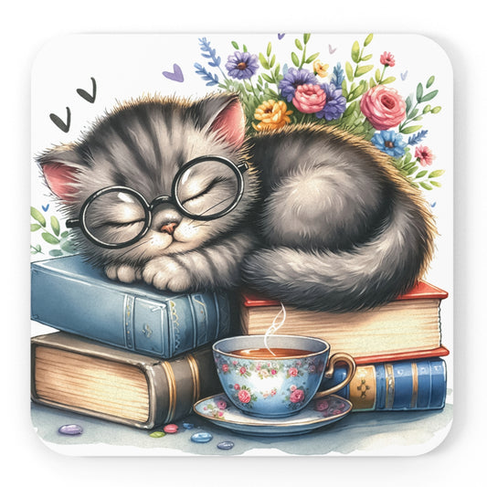 Illustrated coaster featuring a cute gray tabby kitten wearing round glasses, sleeping atop a stack of colorful books, with a floral teacup of steaming tea in front and a bouquet of vibrant flowers in the background."