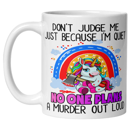 White ceramic mug with a rainbow unicorn holding an axe, framed by a rainbow and clouds, with humorous text about being quiet and planning a murder.
