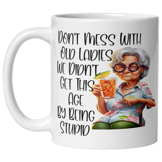 Don't Mess With Old Ladies funny old lady coffee mug featuring a sarcastic cartoon grandma holding an iced drink, novelty gift for grandma with humorous quote and colourful artwork.