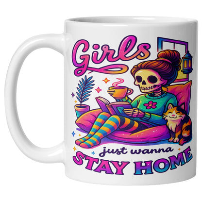 Girls Just Wanna Stay Home Mug featuring a colourful skeleton relaxing on a cosy sofa with a coffee, book, cat, lantern, and houseplants, funny homebody coffee mug for introverts, book lovers, and cat lovers.