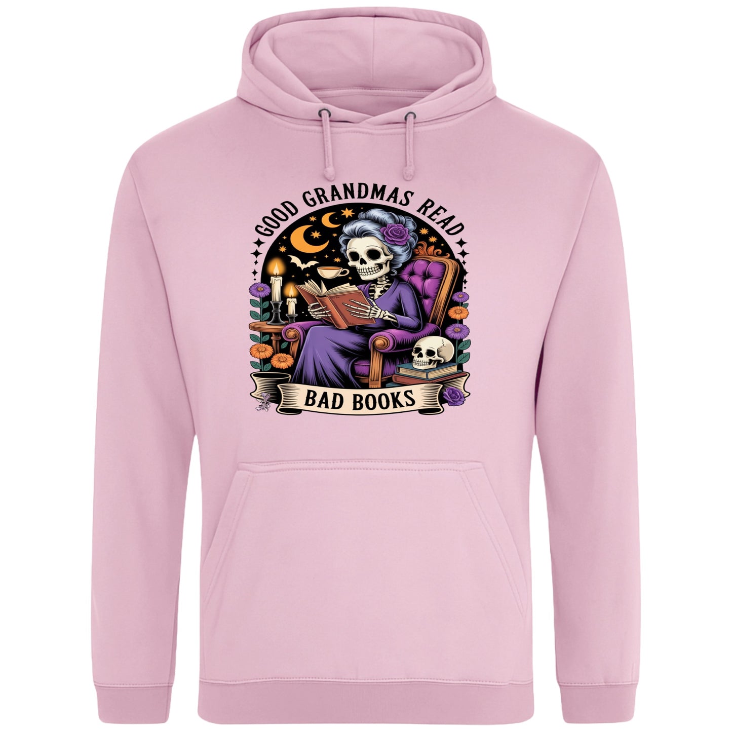 Pink Good Grandmas Read Bad Books Hoodie featuring a spooky cute skeleton grandma reading in a cosy armchair with candles and flowers, funny grandma hoodie for book lovers and gothic readers.