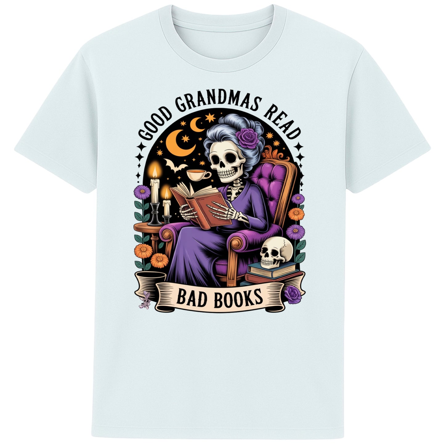 Blue ice colour Good Grandmas Read Bad Books T-Shirt featuring a spooky cute skeleton grandma reading in a cosy armchair with candles and flowers, funny grandma t shirt for book lovers and gothic book lovers.