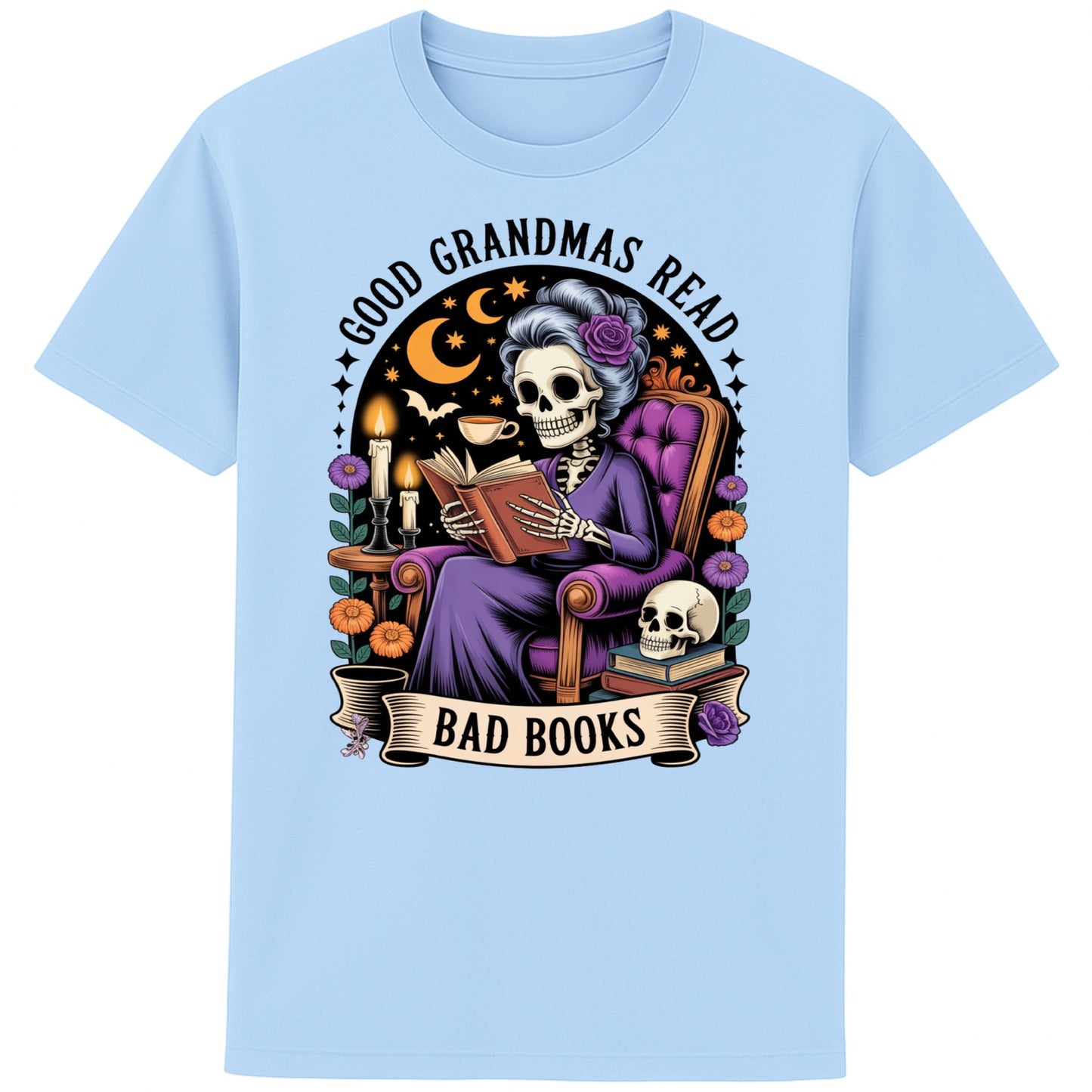 Blue Soul colour Good Grandmas Read Bad Books T-Shirt featuring a spooky cute skeleton grandma reading in a cosy armchair with candles and flowers, funny grandma t shirt for book lovers and gothic book lovers.