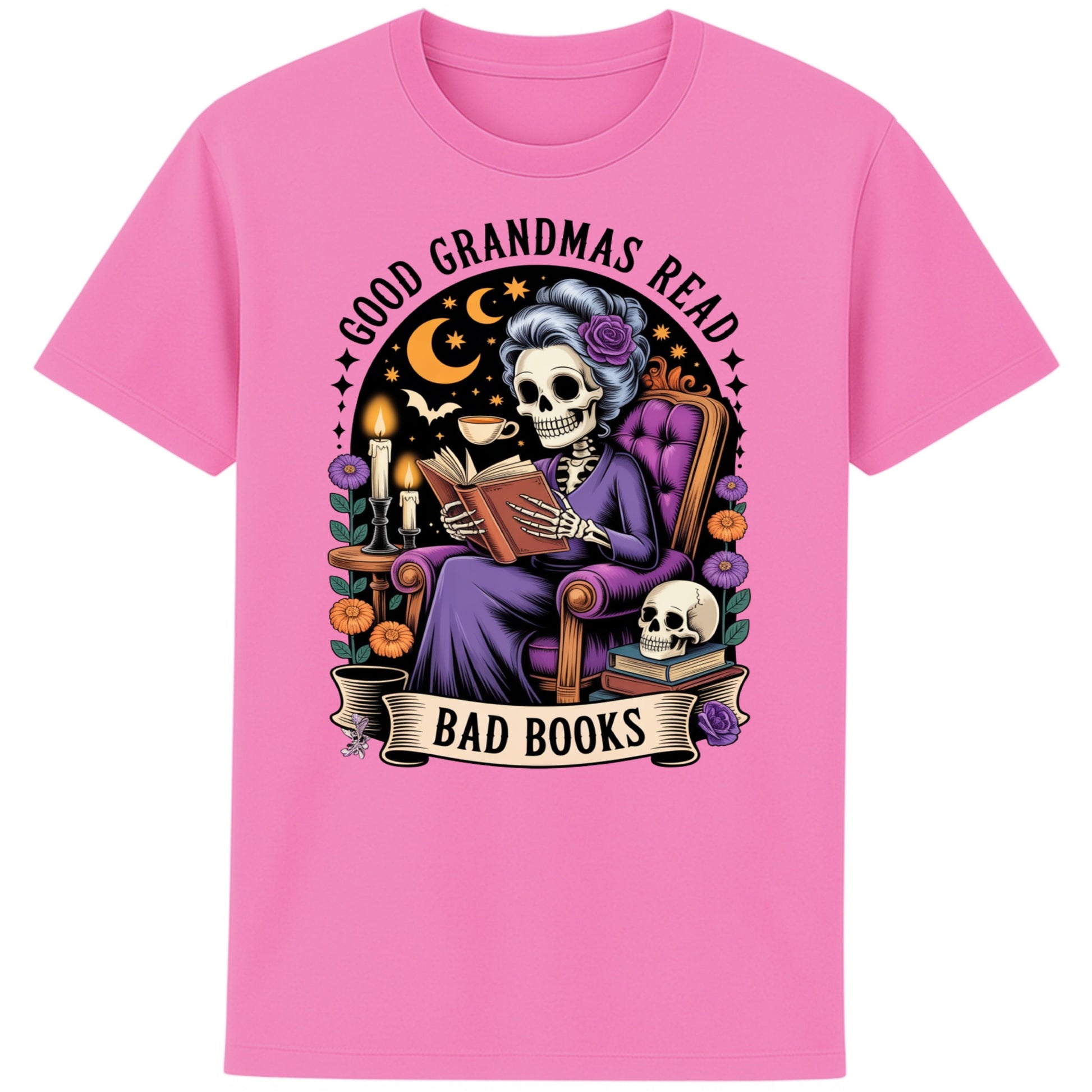 Bubble pink colour Good Grandmas Read Bad Books T-Shirt featuring a spooky cute skeleton grandma reading in a cosy armchair with candles and flowers, funny grandma t shirt for book lovers and gothic book lovers.