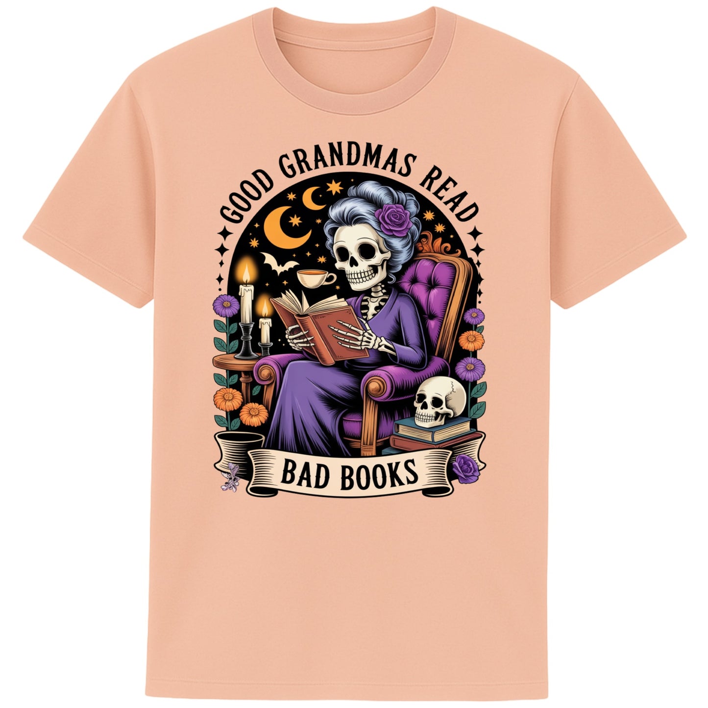 Fraiche peche colour Good Grandmas Read Bad Books T-Shirt featuring a spooky cute skeleton grandma reading in a cosy armchair with candles and flowers, funny grandma t shirt for book lovers and gothic book lovers.