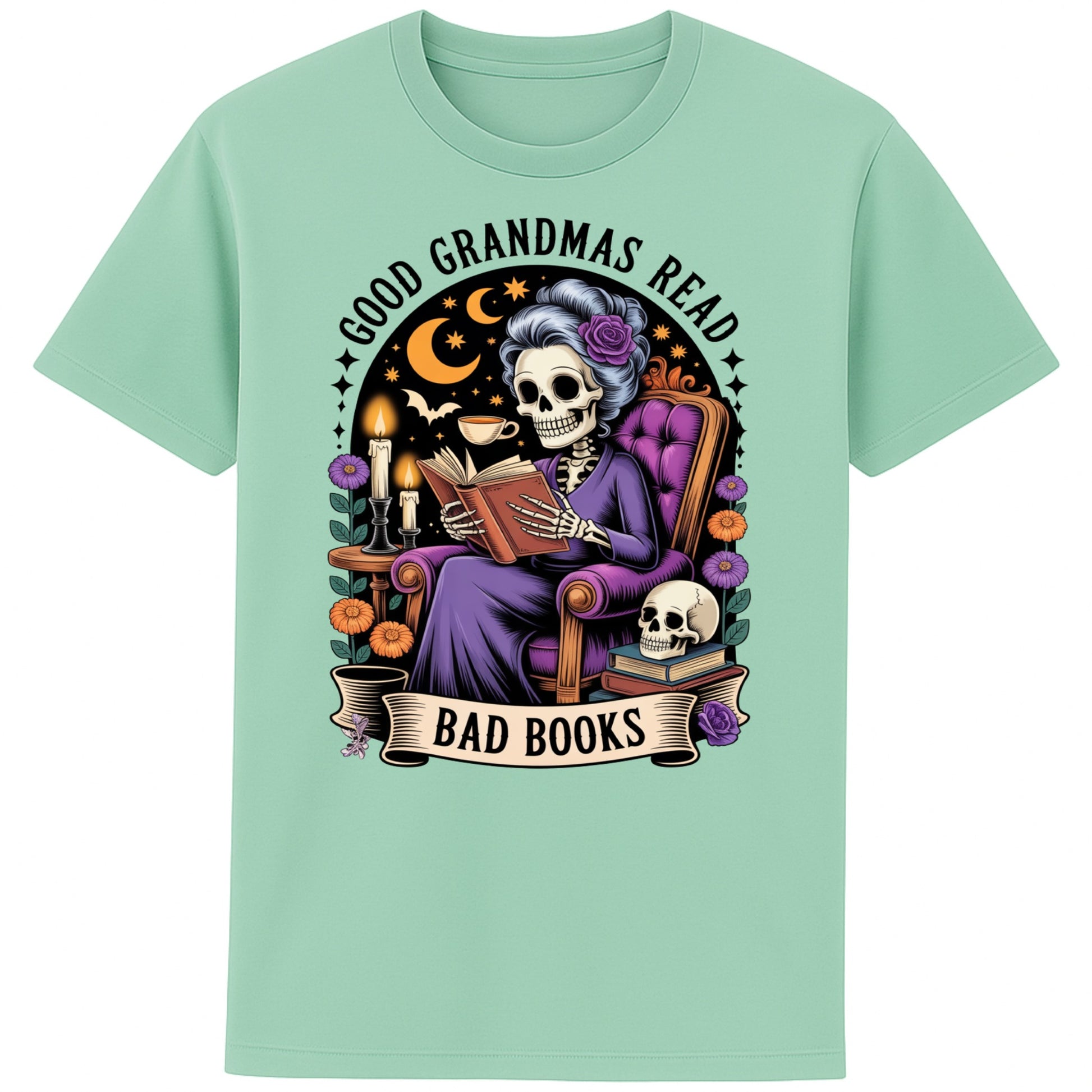 Misty Jade colour Good Grandmas Read Bad Books T-Shirt featuring a spooky cute skeleton grandma reading in a cosy armchair with candles and flowers, funny grandma t shirt for book lovers and gothic book lovers.