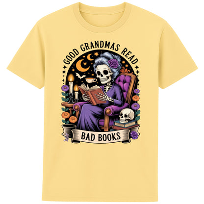 Yellow Good Grandmas Read Bad Books T-Shirt featuring a spooky cute skeleton grandma reading in a cosy armchair with candles and flowers, funny grandma t shirt for book lovers and gothic book lovers.
