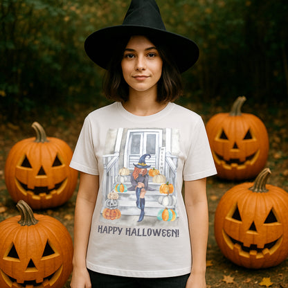 Person wearing a white t-shirt with a Halloween design and text, surrounded by pumpkins.