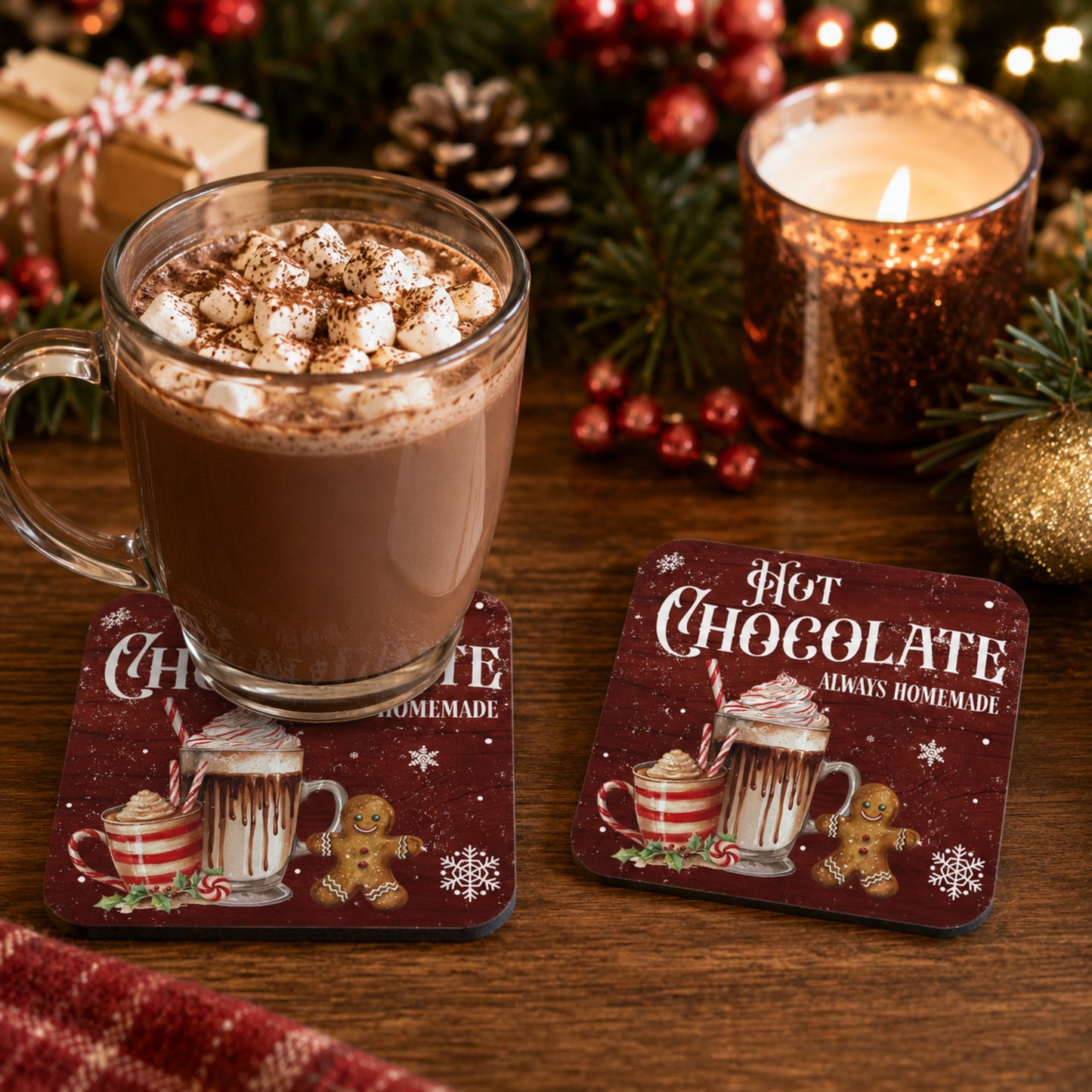 Festive Hot Chocolate Always Homemade cork coaster with a glass mug of hot chocolate topped with marshmallows, alongside a matching Christmas coaster on a wooden table with a candle, pinecones, and holiday decorations. Perfect Christmas drink coaster and hot cocoa home décor gift.