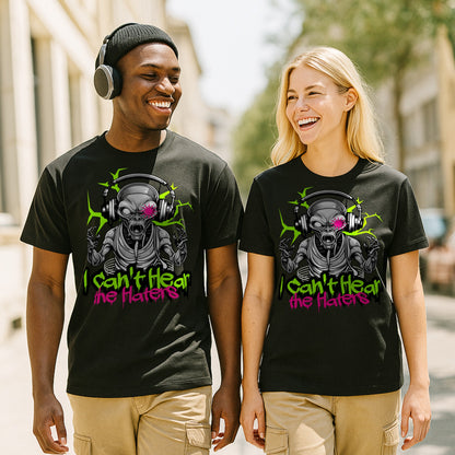 Two people wearing black t-shirts with a alien graphic design and text saying I cant hear  the haters, standing outdoors.