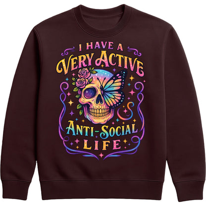 I Have A Very Active Anti Social Life sweatshirt featuring a colourful neon sugar skull, butterfly, and floral graphic on a hot chocolate colour unisex graphic sweatshirt, perfect for introverts who love sarcastic humour, alternative fashion, and cosy everyday style.