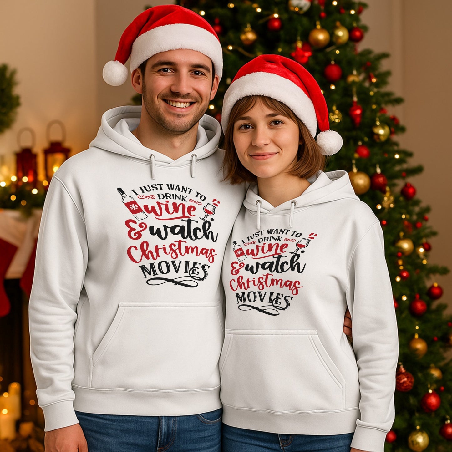 Smiling couple wearing matching I Just Want To Drink Wine & Watch Christmas Movies hoodies in front of a decorated Christmas tree, perfect for festive movie nights, cosy holiday evenings, and wine lovers.