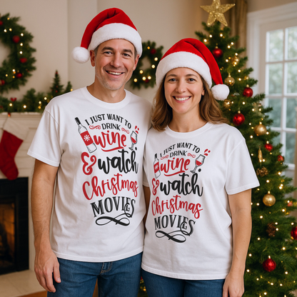 Smiling couple wearing matching I Just Want To Drink Wine & Watch Christmas Movies T-shirts in front of a decorated Christmas tree, perfect for festive movie nights, holiday parties, and wine lovers.