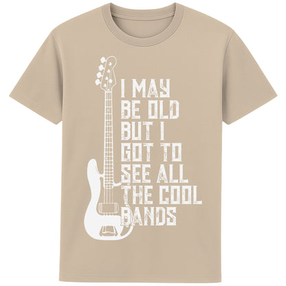 An desert dust colour unisex t-shirt featuring distressed text "I May Be Old But I Saw All the Cool Bands" with a vintage electric bass guitar graphic, perfect for music lovers and retro style fans