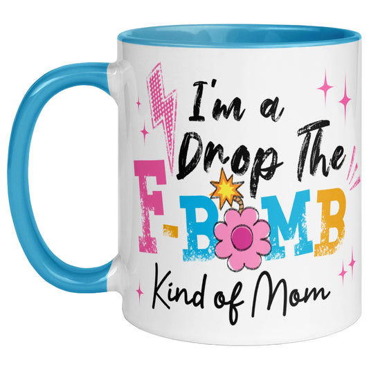 Blue handle and blue interior coffee mug featuring the phrase "I'm A Drop The F-Bomb Kind Of Mom" in colourful retro lettering with floral accents, funny mom coffee mug gift.