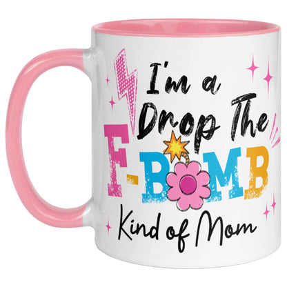 pink handle and pink interior coffee mug featuring the phrase "I'm A Drop The F-Bomb Kind Of Mom" in colourful retro lettering with floral accents, funny mom coffee mug gift.