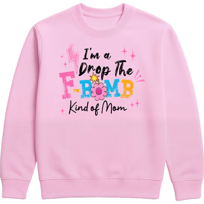 funny baby pink motherhood sweatshirt featuring "I'm A Drop The F-Bomb Kind Of Mom" slogan in colourful retro lettering and floral graphics.