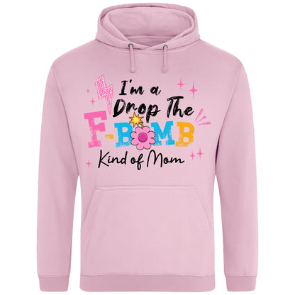 Pink hoodie featuring the phrase "I'm A Drop The F-Bomb Kind Of Mom" in colourful retro typography with floral accents, funny mom hoodie design celebrating real motherhood with humour.