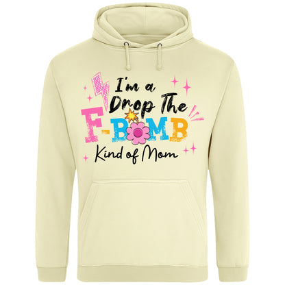 Vanilla milkshake colour hoodie featuring the phrase "I'm A Drop The F-Bomb Kind Of Mom" in colourful retro typography with floral accents, funny mom hoodie design celebrating real motherhood with humour.