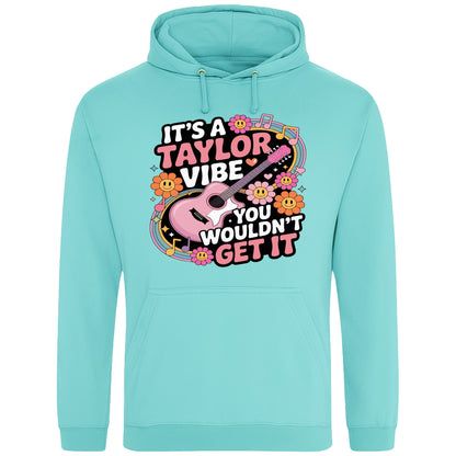 Peppermint colour It's A Taylor Vibe You Wouldn't Get It retro music fan hoodie in pink featuring a colourful guitar, flowers, rainbow accents, musical notes, and playful typography for pop music lovers and concert fans.