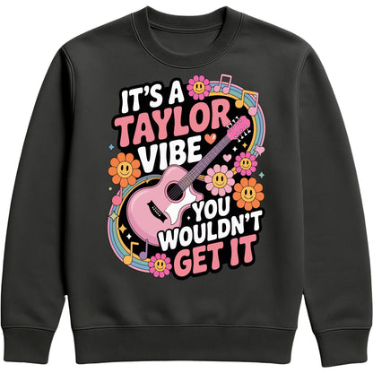 Cosy black It's A Taylor Vibe You Wouldn't Get It retro music fan sweatshirt in pink featuring a colourful guitar, flowers, rainbow accents, musical notes, and playful typography for pop music lovers and concert fans.