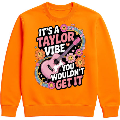 Cosy orange crush colour It's A Taylor Vibe You Wouldn't Get It retro music fan sweatshirt in pink featuring a colourful guitar, flowers, rainbow accents, musical notes, and playful typography for pop music lovers and concert fans.