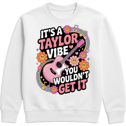 Cosy white It's A Taylor Vibe You Wouldn't Get It retro music fan sweatshirt in pink featuring a colourful guitar, flowers, rainbow accents, musical notes, and playful typography for pop music lovers and concert fans.