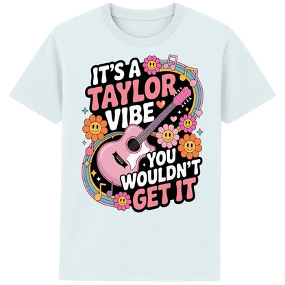 Blue ice colour It's A Taylor Vibe You Wouldn't Get It retro pop music graphic T-shirt in yellow featuring a pink guitar, colourful flowers, music notes, hearts, and playful typography for Taylor-inspired music fans.