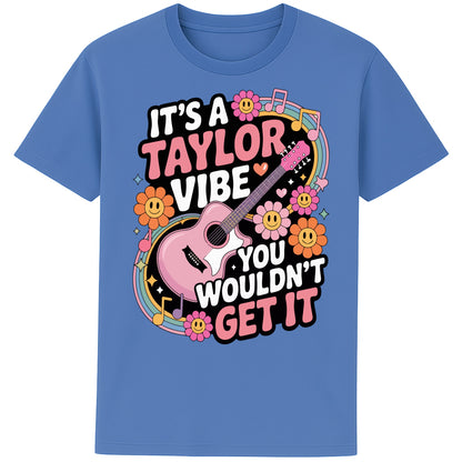 Bright blue It's A Taylor Vibe You Wouldn't Get It retro pop music graphic T-shirt in yellow featuring a pink guitar, colourful flowers, music notes, hearts, and playful typography for Taylor-inspired music fans.