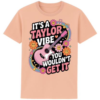 Fraiche peche colour It's A Taylor Vibe You Wouldn't Get It retro pop music graphic T-shirt in yellow featuring a pink guitar, colourful flowers, music notes, hearts, and playful typography for Taylor-inspired music fans.