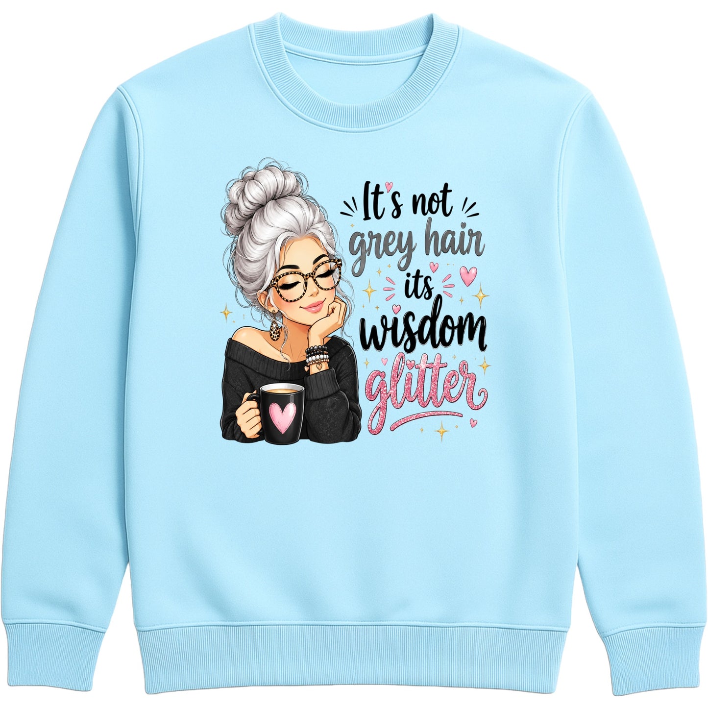 A sky blue crewneck sweatshirt featuring a graphic of an elderly woman with grey hair and glasses holding a mug, next to the text 'It's not grey hair it's wisdom glitter' in black and pink lettering.