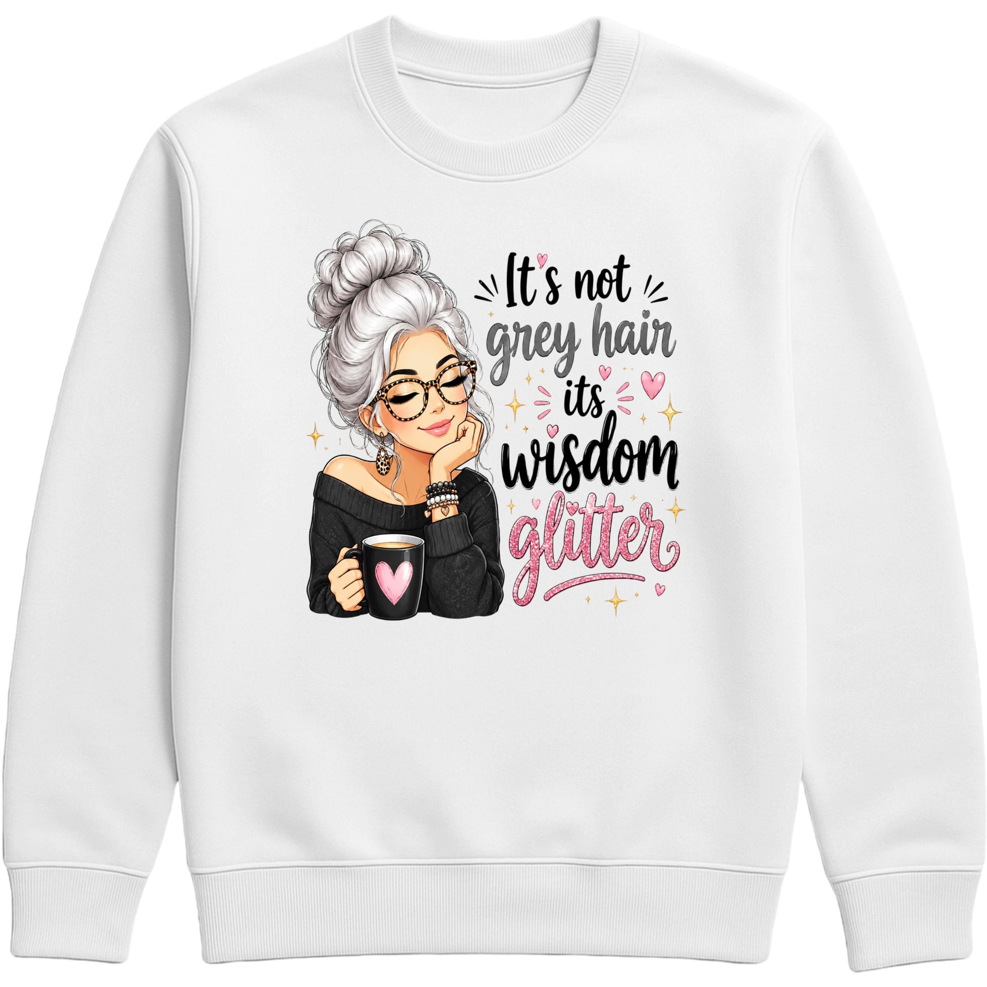 A white crewneck sweatshirt featuring a graphic print of an elderly woman with grey hair, glasses, and a black off-the-shoulder top holding a mug with a pink heart. The text reads 'It's not grey hair, it's wisdom glitter' in black and pink lettering with small pink and gold glitter accents.