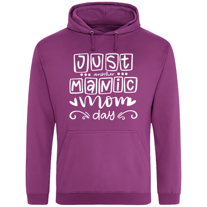 A plum hoodie with 'Just Another Manic Mom Day' printed on the front, styled for casual everyday wear, perfect for moms balancing busy lives.